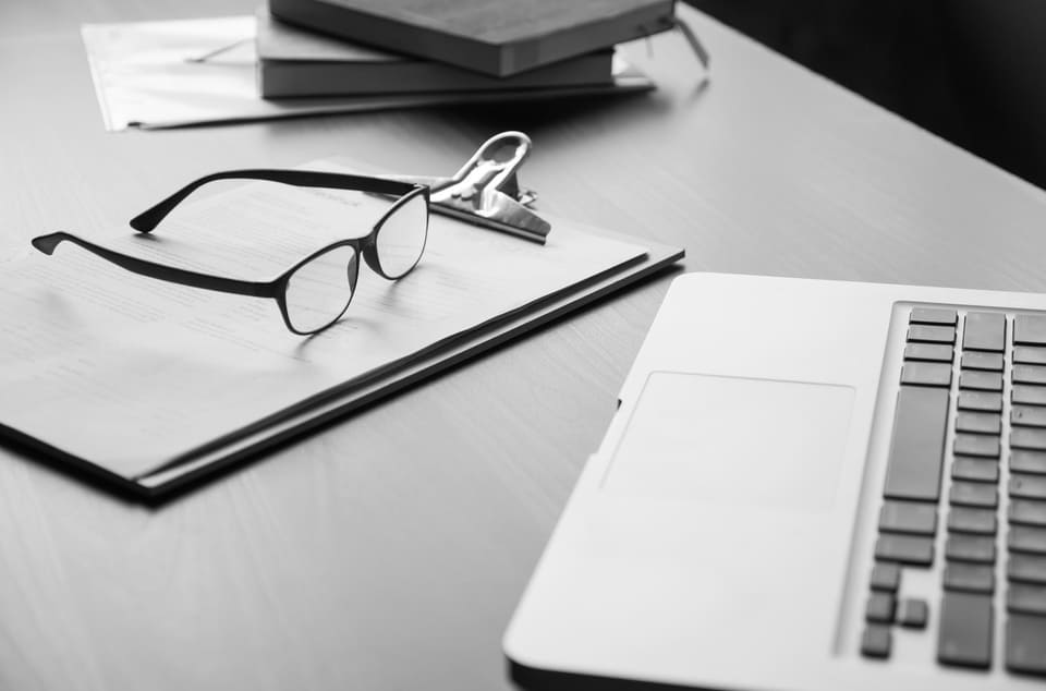 A pair of glasses resting on an open book